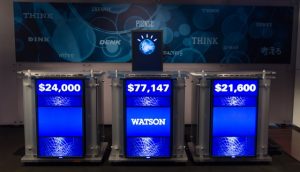 Jeopardy! podiums showing final scores, with IBM Watson in the center.